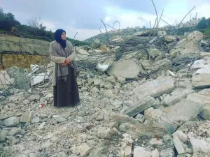 Mother of Palestinian_prisoner Asem al-Barghouti is standing on the rubble of his house which was demolished this night (Twitter)