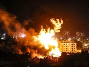 Fire and smoke below above buildings in Gaza City during reported Israeli strikes on March 25, 2019. (AFP)
