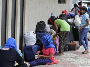 Ethiopian domestic workers who were dismissed by their employers gather with their belongings outside their country’s embassy in Hazmiyeh, east of Beirut, on June 24, 2020. - Around 250,000 migrants -- usually women -- work as housekeepers, nannies and carers in Lebanese homes, a large proportion Ethiopian and some for as little as $150 a month. None are protected by labour law. [Image: AFP]