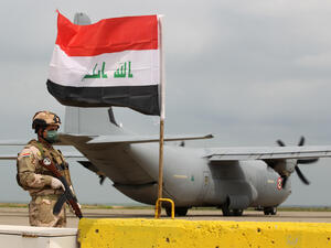 An Iraqi soldier stands guard near a U.S. military air carrier at the Qayyarah Airfield West, before the U.S. transferred the base to Iraqi forces in March. Ahmad Al-Rubaye/AFP via Getty Images