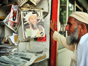 Pakistani man reading newspapers and daily life on May 15, 2011 in Abbottabad, Pakistan (Shutterstock)