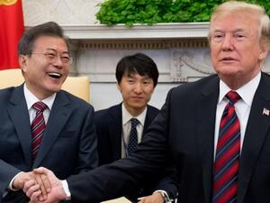 US President Donald Trump and South Korean President Moon Jae In shake hands during a meeting in the Oval Office of the White House. (AFP)