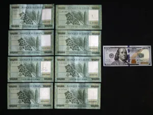 A picture taken on June 29, 2020 shows the black market rate, as calculated by specialised websites, of 100 USD in Lebanese Liras on the day of shoot on June 29. The Lebanese currency officially remains pegged at around 1,507 pounds to the dollar, but the black market rate on Monday morning reached a new record of 8,000, according to several specialised websites. The cap on dollar withdrawals has led those in need of the foreign currency to resort to changers on the black market instead, sending the exchang