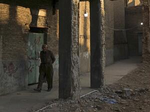 A man walks in the vicinity of Arbil Citadel in the capital of the northern Iraqi Kurdish autonomous region. SAFIN HAMED / AFP