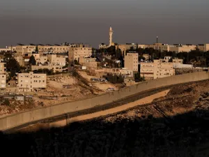 This picture taken on June 30, 2020 shows a view of Israel's controversial separation barrier between the West Bank city of Abu Dis (background) and East Jerusalem (foreground). AHMAD GHARABLI / AFP