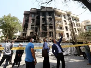 Iranians gather at the cordoned-off site of an explosion at the Sina At'har health centre in the upmarket northern neighbourhood of Tajrish in the capital Tehran on July 1, 2020. Iranian police questioned four people as part of investigations into a powerful explosion that killed 19 people at a Tehran clinic the night before, state media reported. ATTA KENARE / AFP