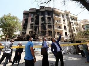Iranians gather at the cordoned-off site of an explosion at the Sina At'har health centre in the upmarket northern neighbourhood of Tajrish in the capital Tehran on July 1, 2020. Iranian police questioned four people as part of investigations into a powerful explosion that killed 19 people at a Tehran clinic the night before, state media reported. ATTA KENARE / AFP