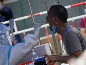 A man receives a swab test during widespread testing for the COVID-19 coronavirus outbreak in Beijing on July 1, 2020. WANG Zhao / AFP