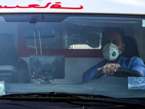A mask-clad driver sits behind the wheel in an ambulance in the central Karrada district of Iraq's capital Baghdad on July 1, 2020. AFP