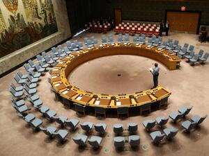 In this file photo taken on September 20, 2017 an official looks at the empty chairs of leaders ahead of their participation in an open debate of the United Nations Security Council in New York. The UN Security Council on July 1, 2020 unanimously adopted a resolution calling for a halt to conflicts to facilitate the fight against the COVID-19 pandemic, after more than three months of painstaking negotiations, diplomats said. Stephane LEMOUTON / POOL / AFP
