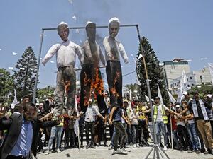 Palestinian supporters of al-Ahrar movement burn effigies depicting (L to R) US President Donald Trump, Trump's Middle East peace plan dubbed as the "Deal of the Century", and Israeli Prime Minister Benjamin Netanyahu, during a demonstration against Israel's plans to annex parts of the occupied West Bank. MOHAMMED ABED / AFP