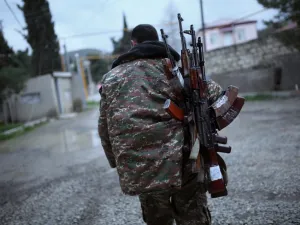 In this file photo taken on April 4, 2016, a soldier of the self-defence army of Nagorno-Karabakh carries weapons in the Martakert region. Azerbaijan on July 7, 2020, raised the spectre of a fresh war with arch-foe Armenia and denounced stalled peace talks over the disputed Nagorny Karabakh region. The two ex-Soviet republics have for decades been locked in a simmering conflict over the breakaway territory, which was at the heart of a bloody war in the 1990s. Vahan Stepanyan / PAN Photo / AFP