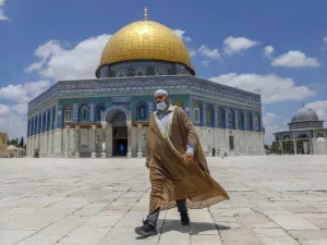 A Palestinian man walks outside the Dome of the Rock Mosque in Jerusalem's al-Aqsa compound amid the COVID-19 pandemic, on July 9, 2020. AHMAD GHARABLI / AFP