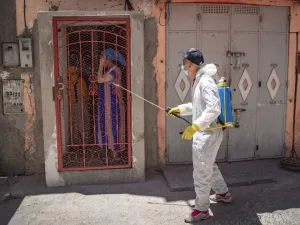 A Moroccan municipal worker disinfects outside a house in a closed street in the southern port city of Safi on June 9, 2020 after Moroccan authorities declared a total lockdown following the discovery of many new COVID-19 coronavirus cases there at a fish canning factory. FADEL SENNA / AFP