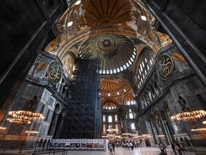 Tourists visit the inside of Hagia Sophia on July 10, 2020, in Istanbul, before a top Turkish court revoked the sixth-century Hagia Sophia's status as a museum, clearing the way for it to be turned back into a mosque. The Council of State, the country's highest administrative court which on July 2 debated a case brought by a Turkish NGO, cancelled a 1934 cabinet decision and ruled the UNESCO World Heritage site would be reopened to Muslim worshipping. The sixth-century Istanbul building -- a magnet for tour