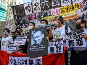 Supporters and activists, who led the June 4 candlelight vigil which commemorates the 1989 Tiananmen Square crackdown in Beijing, shout slogans before attending a mention at the West Kowloon Magistrates Court in Hong Kong on July 13, 2020. (AFP/File)
