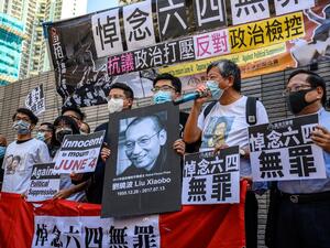Supporters and activists, who led the June 4 candlelight vigil which commemorates the 1989 Tiananmen Square crackdown in Beijing, shout slogans before attending a mention at the West Kowloon Magistrates Court in Hong Kong on July 13, 2020. (AFP/File)