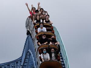 Visitors take a ride on a rollercoaster at the Toshimaen amusement park in Tokyo on July 13, 2020. Kazuhiro NOGI / AFP