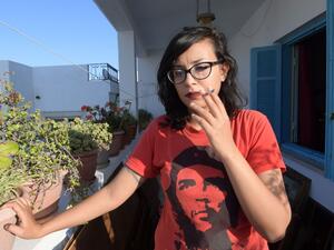 Emna Charki, 27, a Tunisian woman who was sentenced to six months in jail by a Tunis court over a parody posted on Facebook linking the Koran and COVID-19, poses for a picture on July 14, 2020 before starting her jail sentence. (AFP/ File)