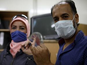 A man and a woman show their ink-stained fingers after voting at a polling station in the Syrian capital Damascus on July 19, 2020, during the parliamentary elections. Syrians vote today to elect a new parliament as the Damascus government grapples with international sanctions and a crumbling economy after retaking large parts of the war-torn country. Louai Beshara / AFP