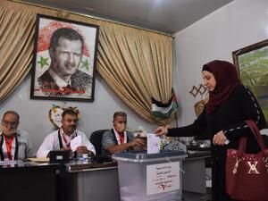 A Syrian woman casts her ballot at a polling station in the Nubl neighbourhood of Aleppo on July 19, 2020, during the parliamentary elections. Syrians vote today to elect a new parliament as the Damascus government grapples with international sanctions and a crumbling economy after retaking large parts of the war-torn country. AFP