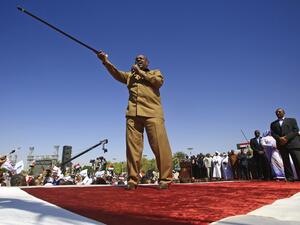 In this file photo taken on January 9, 2019, Sudan's President Omar al-Bashir speaks during a rally with his supporters in the Green Square in the capital Khartoum. Sudan's former autocratic president Omar al-Bashir, ousted amid a popular pro-democracy uprising last year, faces court from July 21 over the coup that brought him to power over three decades ago. ASHRAF SHAZLY / AFP