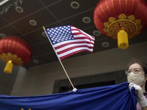 A protester holds a US flag outside of the Chinese consulate in Houston on July 24, 2020, after the US State Department ordered China to close the consulate. The US ordered China to close its Houston consulate, Beijing said on July 22, in what it called a "political provocation" that will further harm diplomatic relations. Mark Felix / AFP