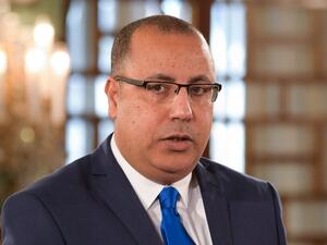 In this file photo taken on February 27, 2020 Tunisian Interior Minister Hichem Mechichi takes the oath of office during the country's new government swearing-in ceremony at the Carthage Palace outside the capital Tunis, on February 27, 2020, following a confidence vote by parliament. Hichem Mechichi, who until now has served as Tunisia's interior minister, has been appointed to form the next government, the president's office said on July 25, 2020. The 46-year-old lawyer succeeds Elyes Fakhfakh, who resig
