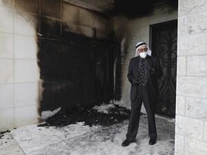 A Palestinian man stands at the entrance of a mosque that was torched and sprayed with graffiti in Hebrew, in Al-Bireh, north of the city of Ramallah in the Israeli-occupied West Bank on July 27, 2020. A mosque in the Israeli-occupied West Bank town of Al-Bireh was defaced by fire damage and Hebrew-language graffiti before dawn today, an attack blamed by Palestinians on Jewish settlers. ABBAS MOMANI / AFP