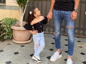 Amre Soulia is seen holding his daughter’s hand while she smiles back at him (Instagram)