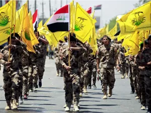Iraqi Shiite Muslims from the Popular Mobilization Units march during a parade marking the annual Quds Day , Baghdad June 2017 /AFP