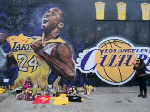 French national and longtime US resident Natalie Burle blows a kiss in direction of Kobe Bryant mural in downtown Los Angeles / © AFP
