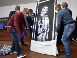 An artwork attributed to Banksy stolen from the Bataclan in Paris in 2019 was found in an abandoned Italian farmhouse. (AFP/File)