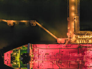 Aerial view oil tanker ship at the port at night, transportation and import export business (Shutterstock)