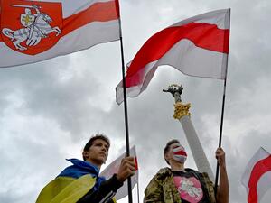 Members of the Belarus diaspora wave national flags during a "Free Belarus" rally at Independence Square in Kiev on August 1, 2020, a week before the Belarus presidential election. Sergei SUPINSKY / AFP
