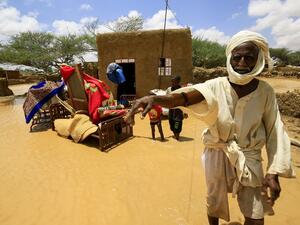 A Sudanese man stands next to his furniture, after torrential rain lead to landslides and flash floods, in the town of Umm Dawan Ban, southeast of the capital Khartoum on August 2, 2020. ASHRAF SHAZLY / AFP