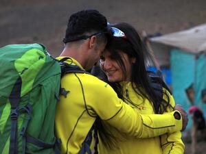 Newlyweds Iraqi Kurds Salar Chomany, 34, and Soma Mohammed, 28, walk together during a trekking ceremony at Mount Halgurd, in Iraq's autotomous Kurdistan region, on the first day of their honeymoon, on August 2, 2020. The couple met while hiking in the mountain, a sport that gained popularity recently in Iraqi Kurdish areas, and decided it would be the theme of their wedding. SAFIN HAMED / AFP
