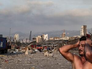 A man reacts at the scene of an explosion at the port in Lebanon's capital Beirut on August 4, 2020. Two huge explosion rocked the Lebanese capital Beirut, wounding dozens of people, shaking buildings and sending huge plumes of smoke billowing into the sky. Lebanese media carried images of people trapped under rubble, some bloodied, after the massive explosions, the cause of which was not immediately known.  IBRAHIM AMRO / AFP