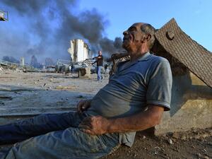 A wounded man sits on the ground waiting for aid at Beirut's port following a massive explosion that hit the heart of the Lebanese capital on August 4, 2020. Rescuers searched for survivors in Beirut on August 5 after a cataclysmic explosion at the port sowed devastation across entire neighbourhoods, killing more than 100 people, wounding thousands and plunging Lebanon deeper into crisis. AFP