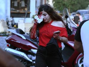 A wounded woman covers her eye following of an explosion at the port of the Lebanese capital Beirut, on August 4, 2020. Rescuers searched for survivors in Beirut after a cataclysmic explosion at the port sowed devastation across entire neighbourhoods, killing more than 100 people, wounding thousands and plunging Lebanon deeper into crisis. AFP