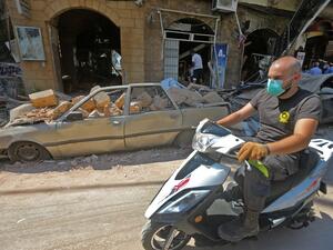 A man wearing a protective mask against the coronavirus rides his motorbike past damaged cars and shops in Beirut's commercial Gemmayzeh district, one day after a powerful twin explosion tore through Lebanon's capital, resulting from the ignition of a huge depot of ammonium nitrate at the city's main port. Rescuers searched for survivors in Beirut after a cataclysmic explosion at the port sowed devastation across entire neighbourhoods, killing more than 100 people, wounding thousands and plunging Lebanon de