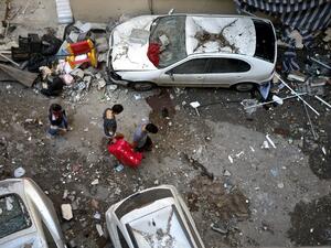 Lebanese carry a suitcase as they leave their damaged apartment in the trendy Beirut neighbourhood of Mar Mikhael on August 6, 2020 in the aftermath of a massive explosion in the Lebanese capital. PATRICK BAZ / AFP
