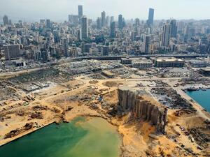 An aerial view taken on August 7, 2020, shows a partial view of the port of Beirut, the damaged grain silo and the crater caused by the colossal explosion three days earlier of a huge pile of ammonium nitrate that had languished for years in a port warehouse, leaving scores of people dead or injured and causing devastation in the Lebanese capital. The city of Beirut can be seen in the background. AFP