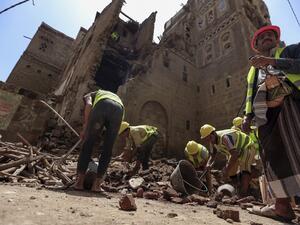 Yemeni labourers remove the rubble ahead of restoration works on the site of a collapsed UNESCO-listed building following heavy rains, in the old city of the Yemeni capital Sanaa, on August 12, 2020. Mohammed HUWAIS / AFP