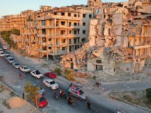A wedding convoy drives along a road at the heavily damaged Jabal al-Arbain hiltop residential area, in the Syrian town of Ariha in the rebel-held northwestern Syrian Idlib province on August 14, 2020. Omar HAJ KADOUR / AFP