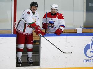 This file photo taken on February 7, 2020 shows Russian President Vladimir Putin (R) and Belarusian President Alexander Lukashenko stepping onto the ice as they take part in an ice hockey match at Rosa Khutor outside the Black Sea resort of Sochi. Belarusian President Alexander Lukashenko discussed the protests shaking his country with Russian counterpart Vladimir Putin on August 15, Belarusian state news agency Belta reported. Alexander Zemlianichenko / POOL / AFP