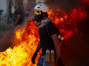 Iraqi demonstrators gather near burning tires during a protest near the governor's residence in the southern city of Basra, to protest assassinations and demand the resignation of top security officials in the southern Iraqi governorate, on August 17, 2020. Hussein FALEH / AFP