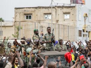 Armed members of the FAMA (Malian Armed Forces) are celebrated by the population as they parade at Independence Square in Bamako on August 18, 2020, after rebel troops seized Malian President Ibrahim Boubacar Keita and Prime Minister Boubou Cisse in a dramatic escalation of a months-long crisis. 