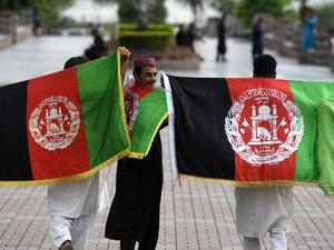 Afghan tourists hold their national flags as they visit Rawal Lake park in Islamabad on August 19, 2020, after the government announced most of the country's remaining restrictions would be lifted following the drop in new COVID-19 coronavirus cases for several weeks. Aamir QURESHI / AFP