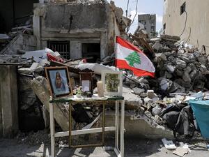 This picture taken on August 19, 2020 shows a make-shift Christian shrine with icons depicting Jesus Christ and the Virgin Mary, in memory of Claudette Yuhanna Saade, a Lebanese woman who was killed in the aftermath of the blast at the port of Beirut. JOSEPH EID / AFP